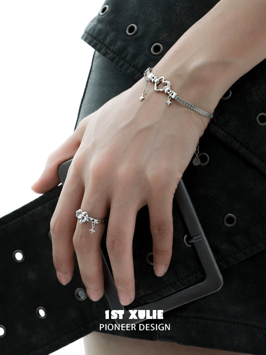 Punk celestial heart silver ring showcased with matching bracelet on a model's hand