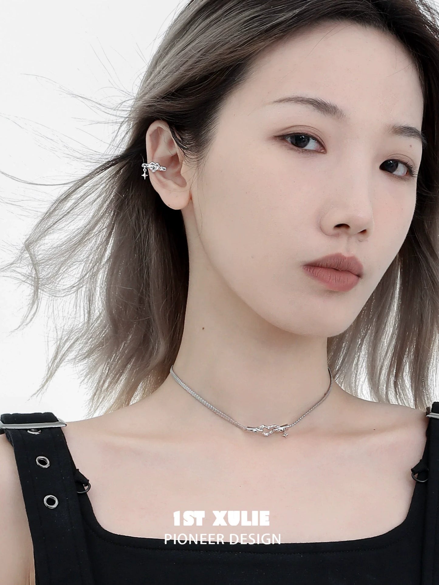 Punk heart necklace from 1STXULIE showcased on a model with layered silver chains