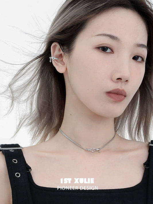 Punk heart necklace from 1STXULIE showcased on a model with layered silver chains