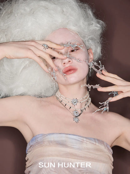 Model showcasing SUN HUNTER punk heart rivet ring with an artistic hair and makeup design