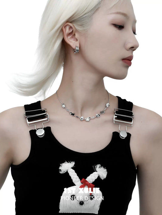 Model showcasing a punk puppy necklace with silver charms, styled with a black outfit