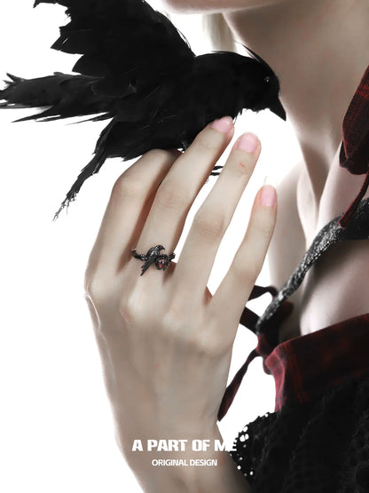 Elegant raven heart ring from A PART OF ME showcased on a hand with a raven accessory