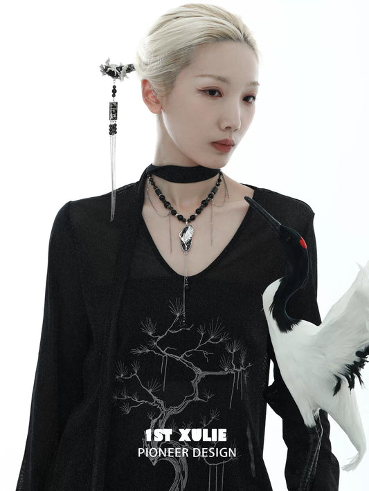 Model wearing a rebellious crane tassel necklace with elegant design and intricate details