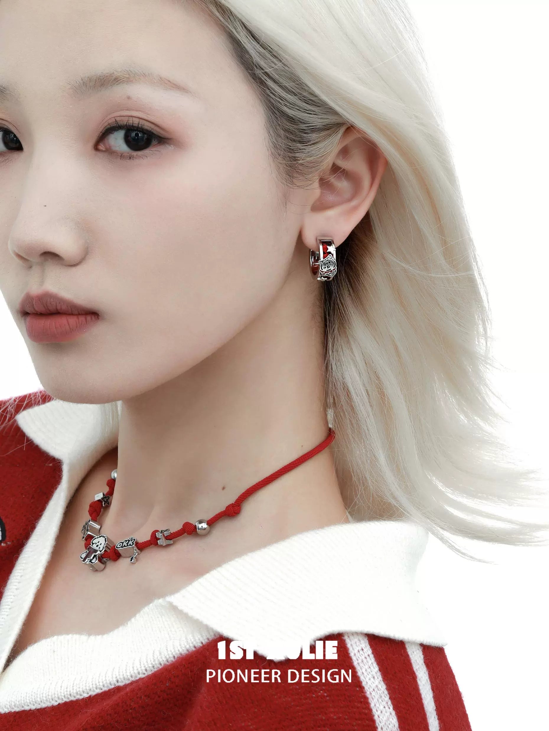 1STXULIE red puppy earrings shown on model with stylish silver details and a chic outfit