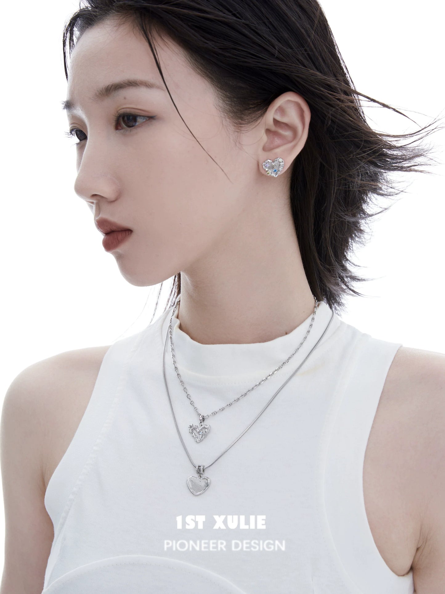 Model wearing a removable clavicle chain necklace with heart pendants from 1ST XULIE