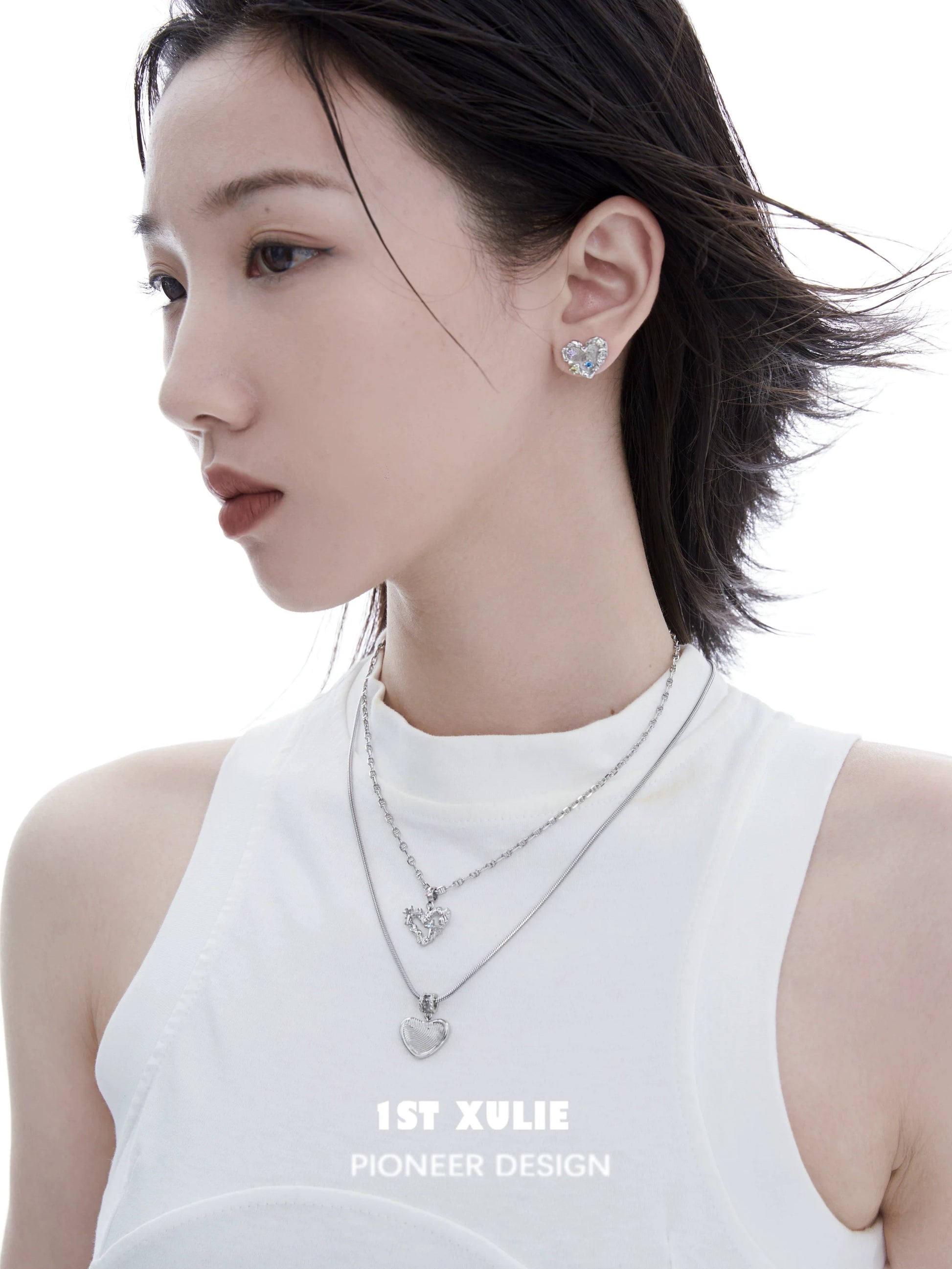 Model wearing a removable clavicle chain necklace with heart pendants from 1ST XULIE