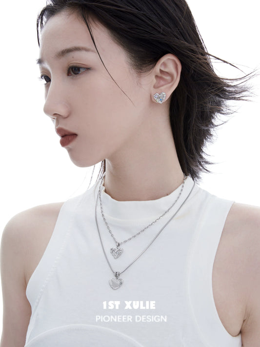 Model wearing a removable clavicle chain necklace with heart pendants from 1ST XULIE