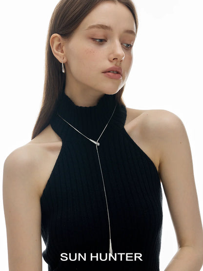 Stylish model wearing SUN HUNTER retro metal water drop earrings with a chic halter neck top