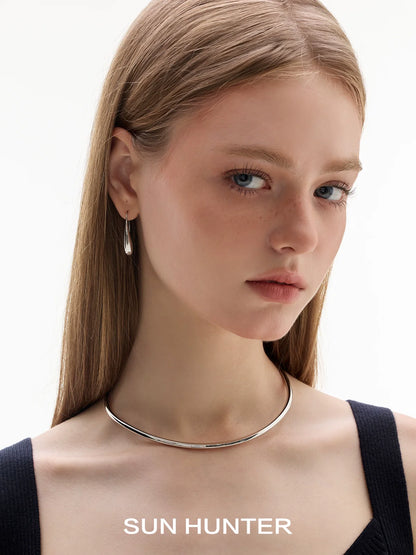 SUN HUNTER Retro Metal Water Drop Earrings worn in a stylish look with a sleek necklace