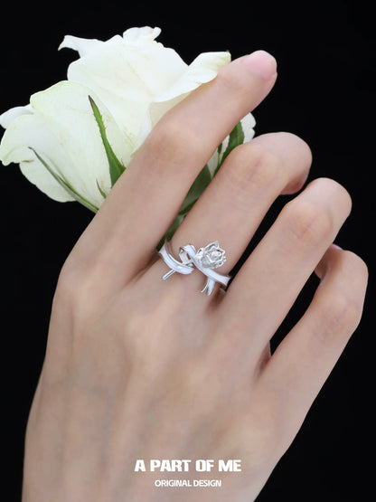 Rose bow silver ring from A PART OF ME, elegantly wrapped with floral design on a woman's hand