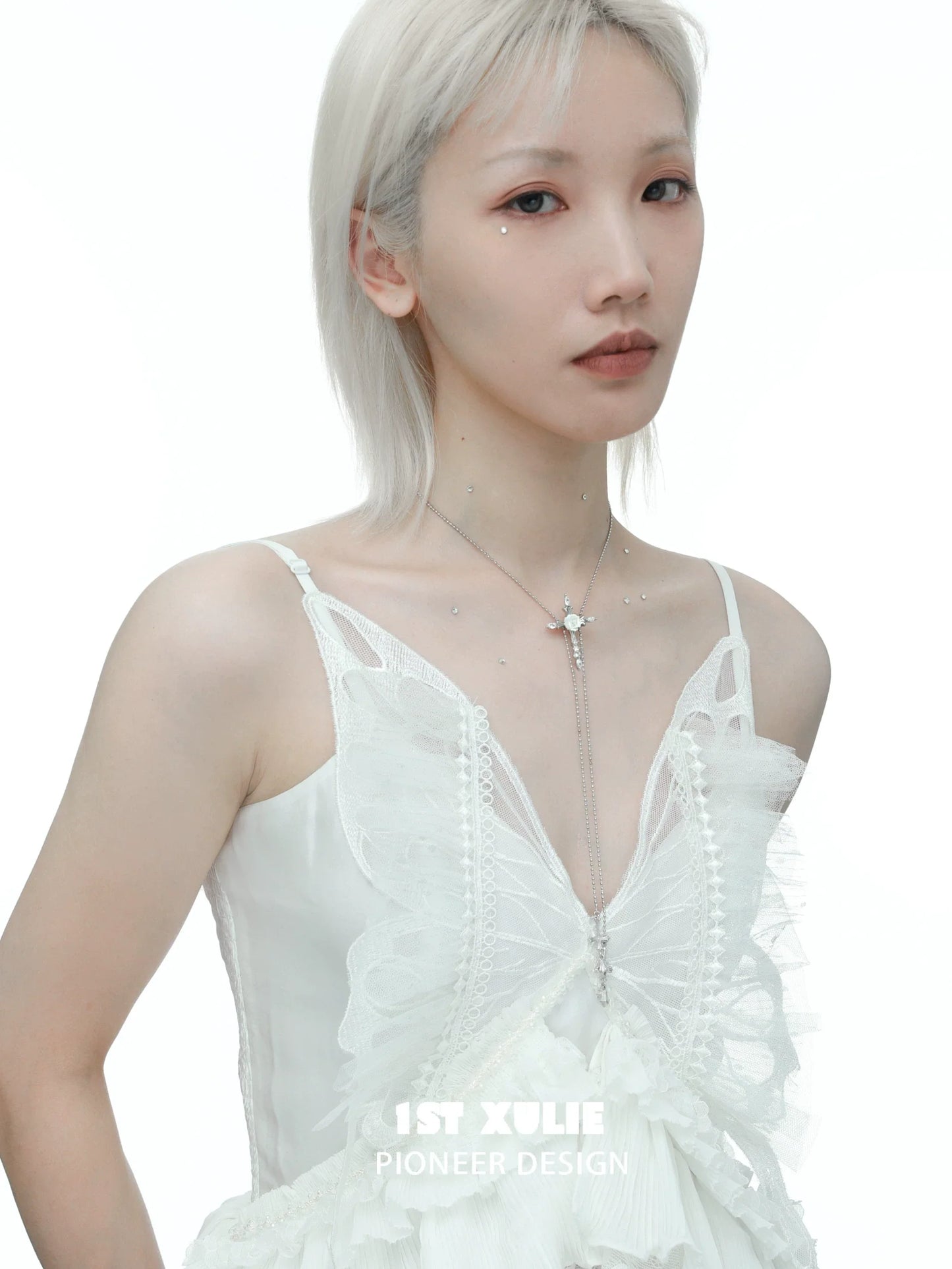 Elegant rose cross necklace from 1STXULIE worn by a model in a bridal dress