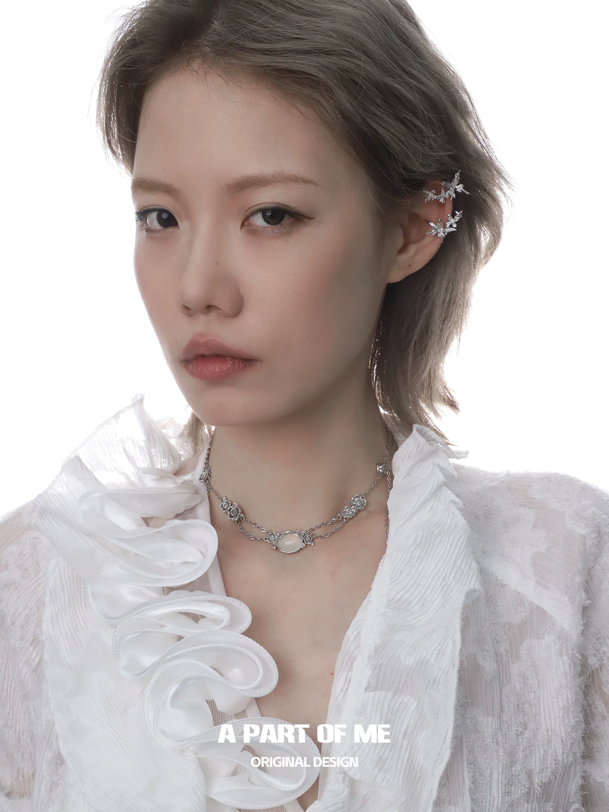 Elegant rose silver necklace displayed on model with intricate design and soft lighting
