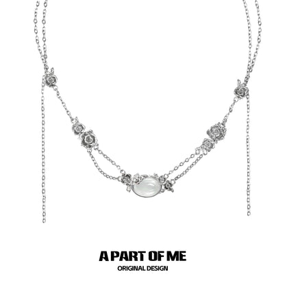 Elegant rose silver necklace with floral accents and a central gemstone design