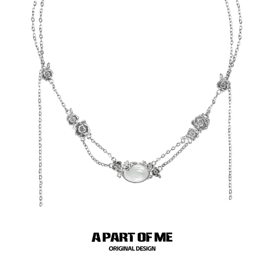 Elegant rose silver necklace with floral accents and a central gemstone design