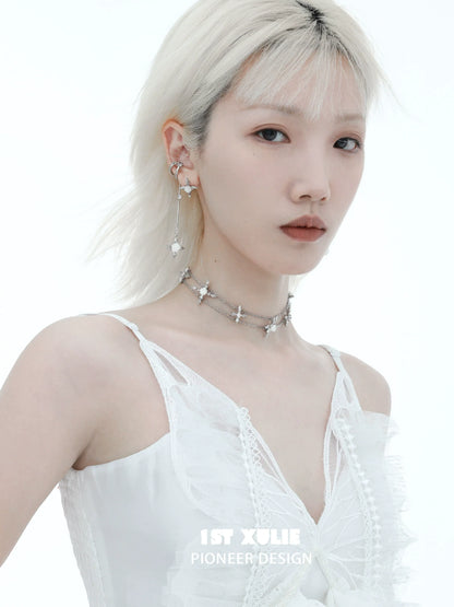 Chic model wearing sacred rose cross earrings with a delicate design for a trendy look