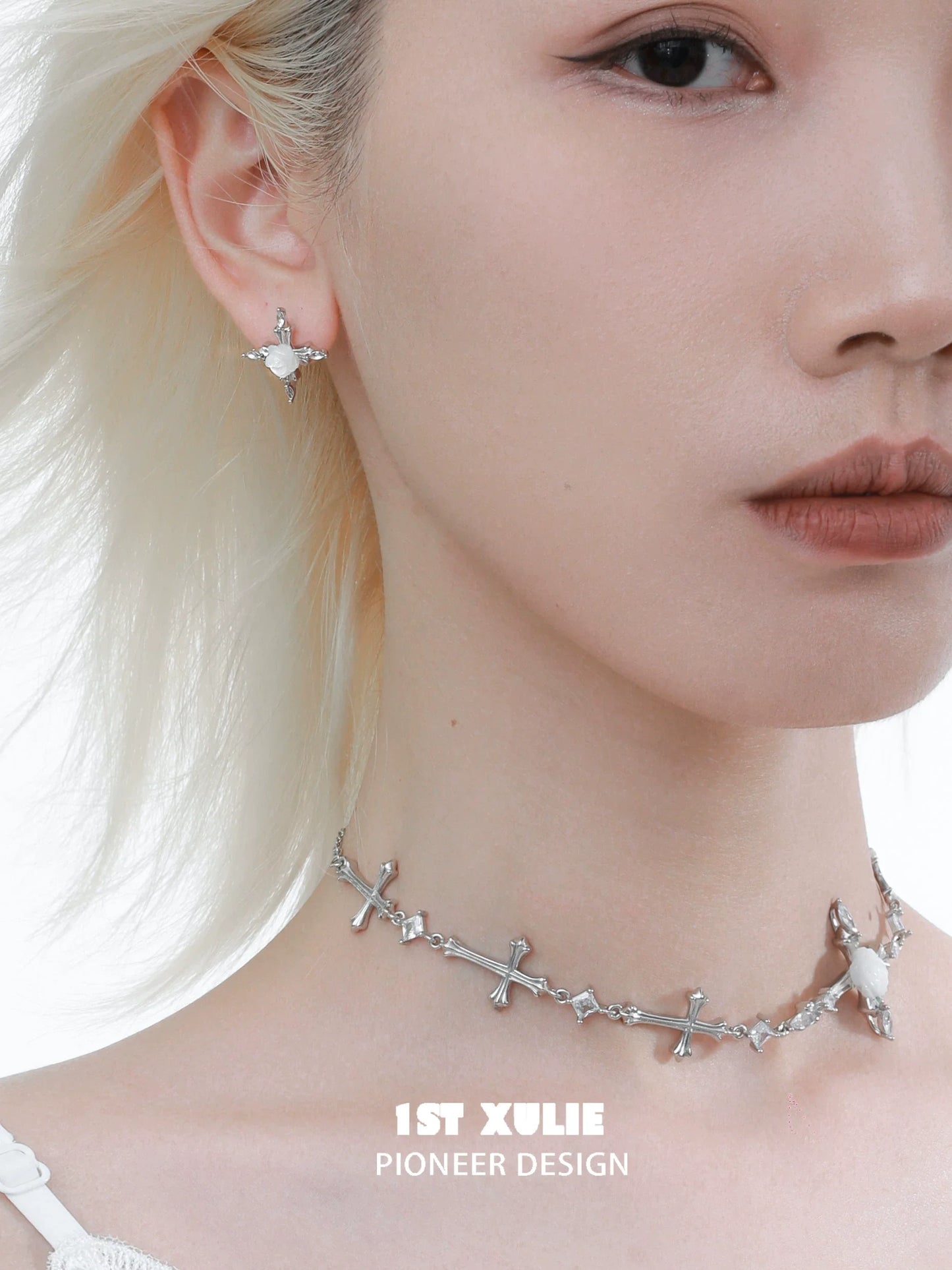 Sacred rose cross earrings in silver, designed by 1STXULIE, worn with matching choker for a chic look