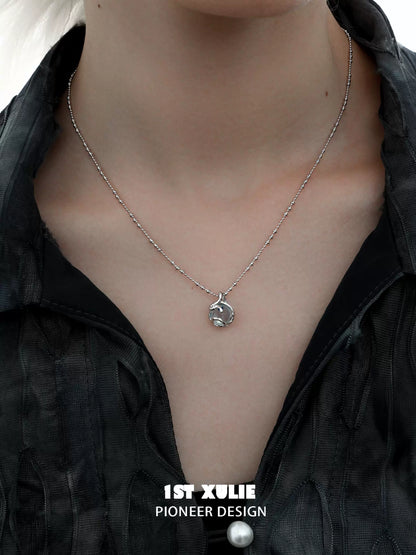 Stylish serpent silver necklace on model with a modern black outfit for a trendy look