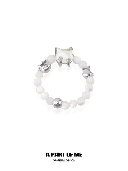 Stylish shell cat beaded ring featuring silver accents and white beads, perfect for unique accessories