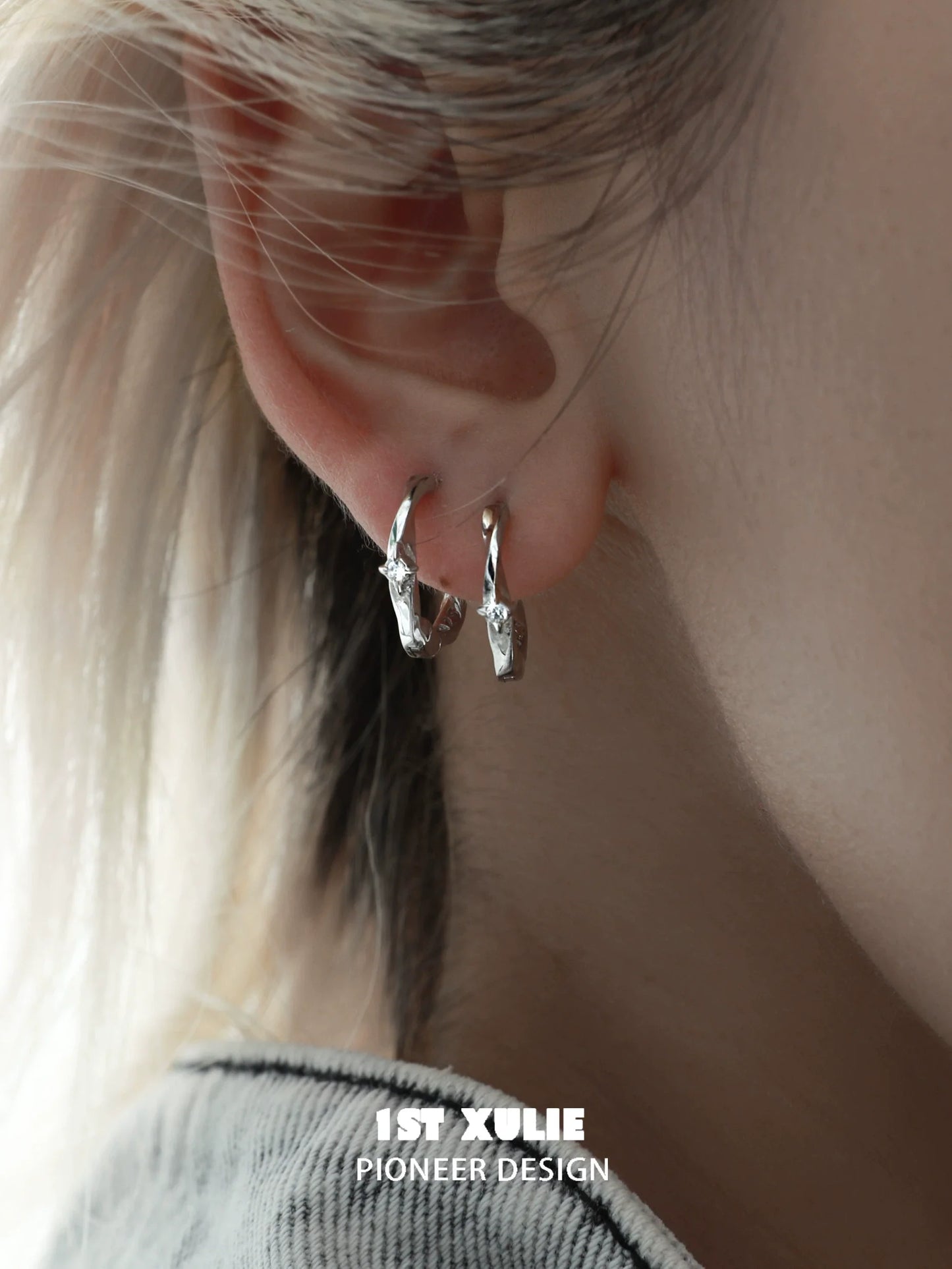 Shooting star silver earrings displayed on an ear with a modern design for stylish elegance