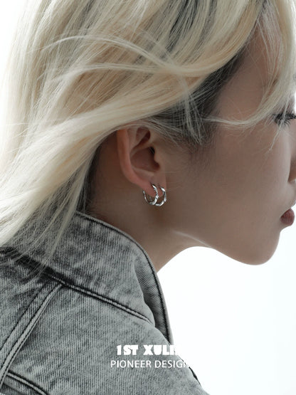 Model wearing shooting star silver earrings showcasing a sleek and modern design