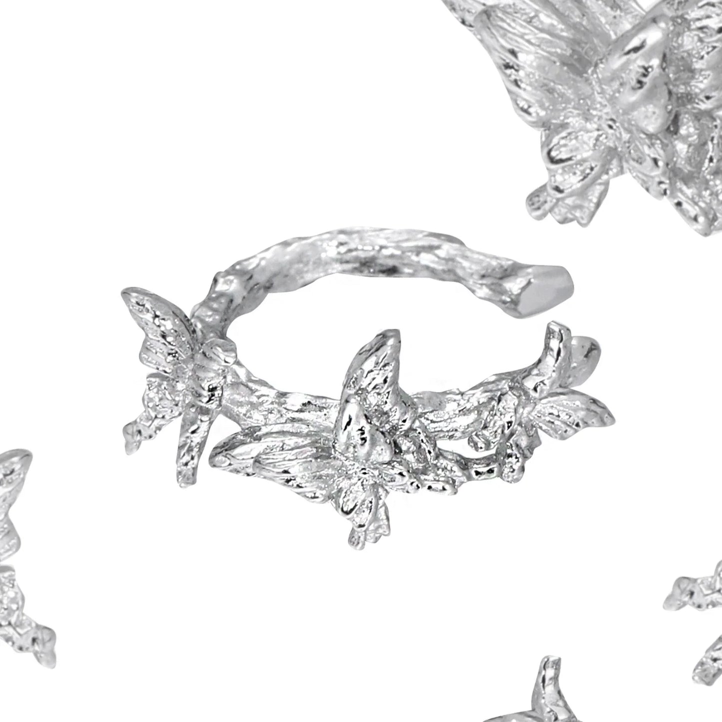 Elegant silver butterfly ear cuff featuring intricate butterfly designs and a stylish wrap-around style