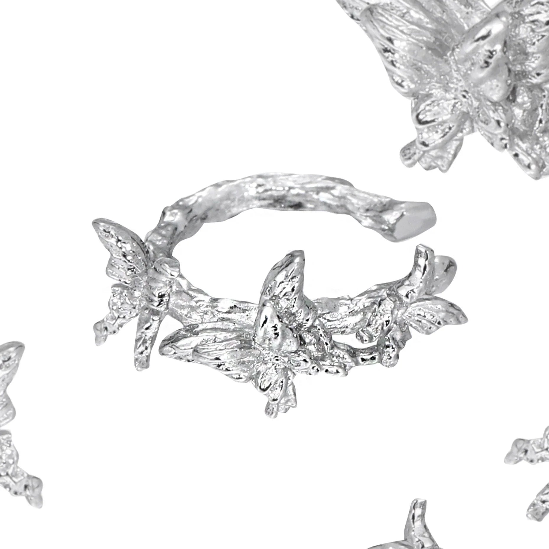 Elegant silver butterfly ear cuff featuring intricate butterfly designs and a stylish wrap-around style