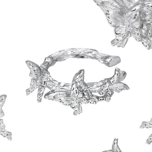 Elegant silver butterfly ear cuff featuring intricate butterfly designs and a stylish wrap-around style