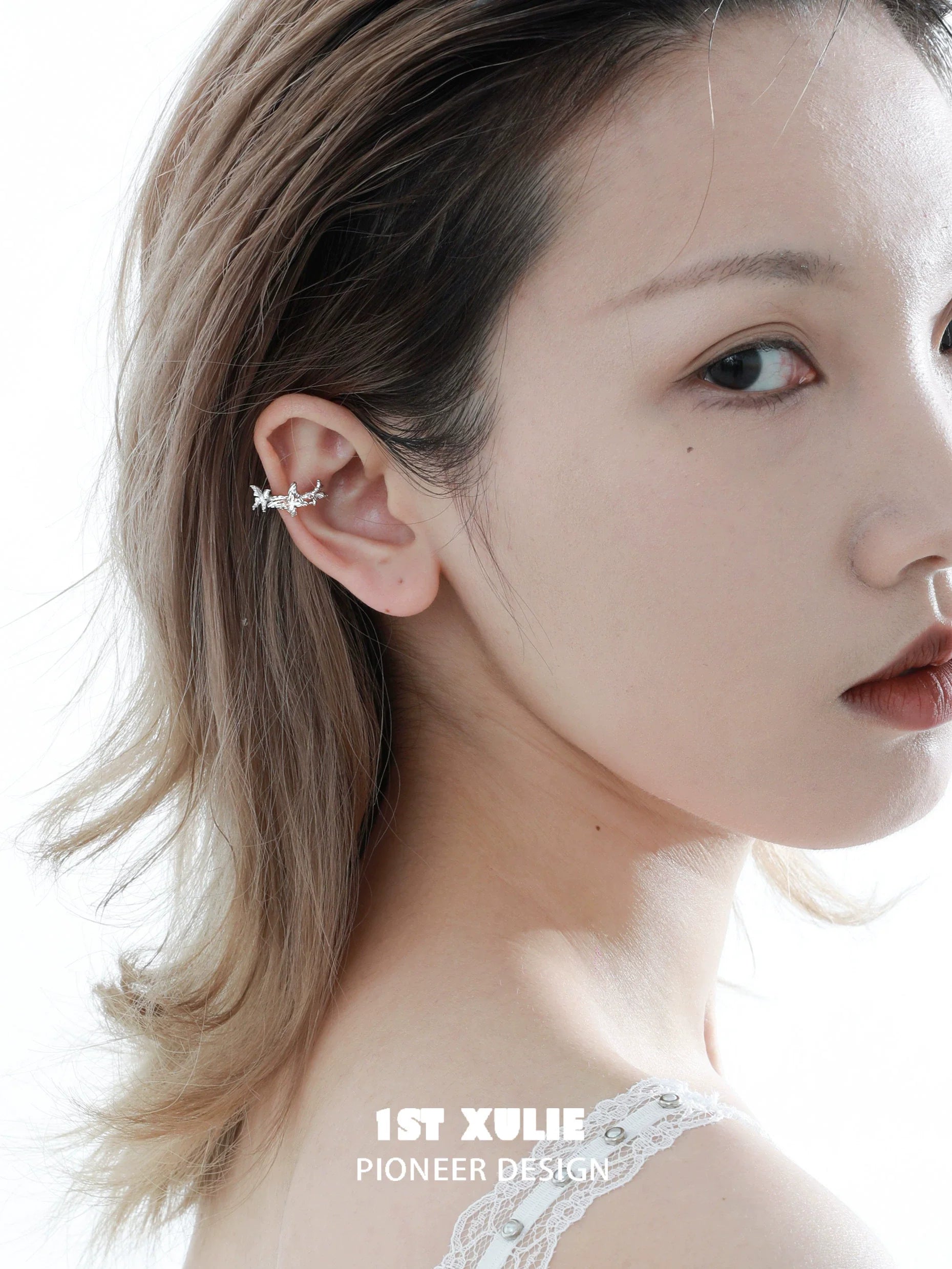 Elegant silver butterfly ear cuff showcased on model for a stylish accessory look