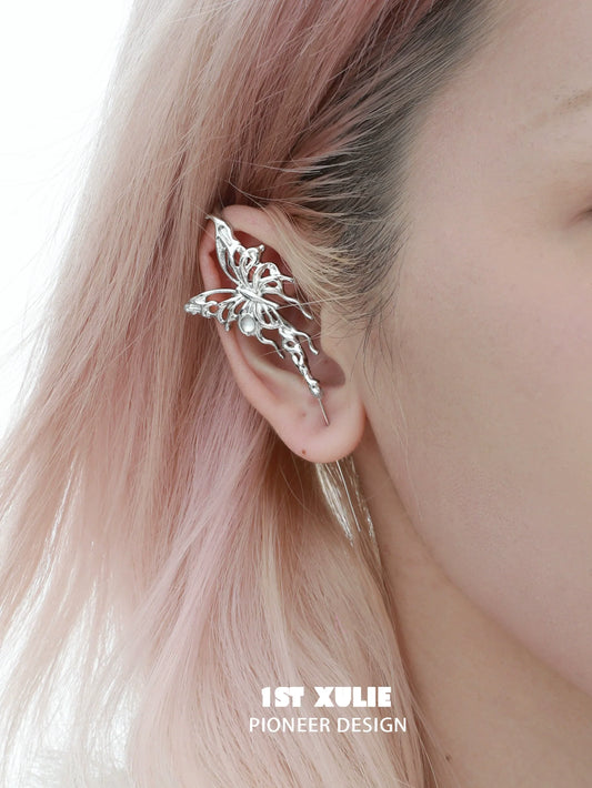 Elegant silver butterfly piercing earring designed by 1STXULIE, worn on a model's ear