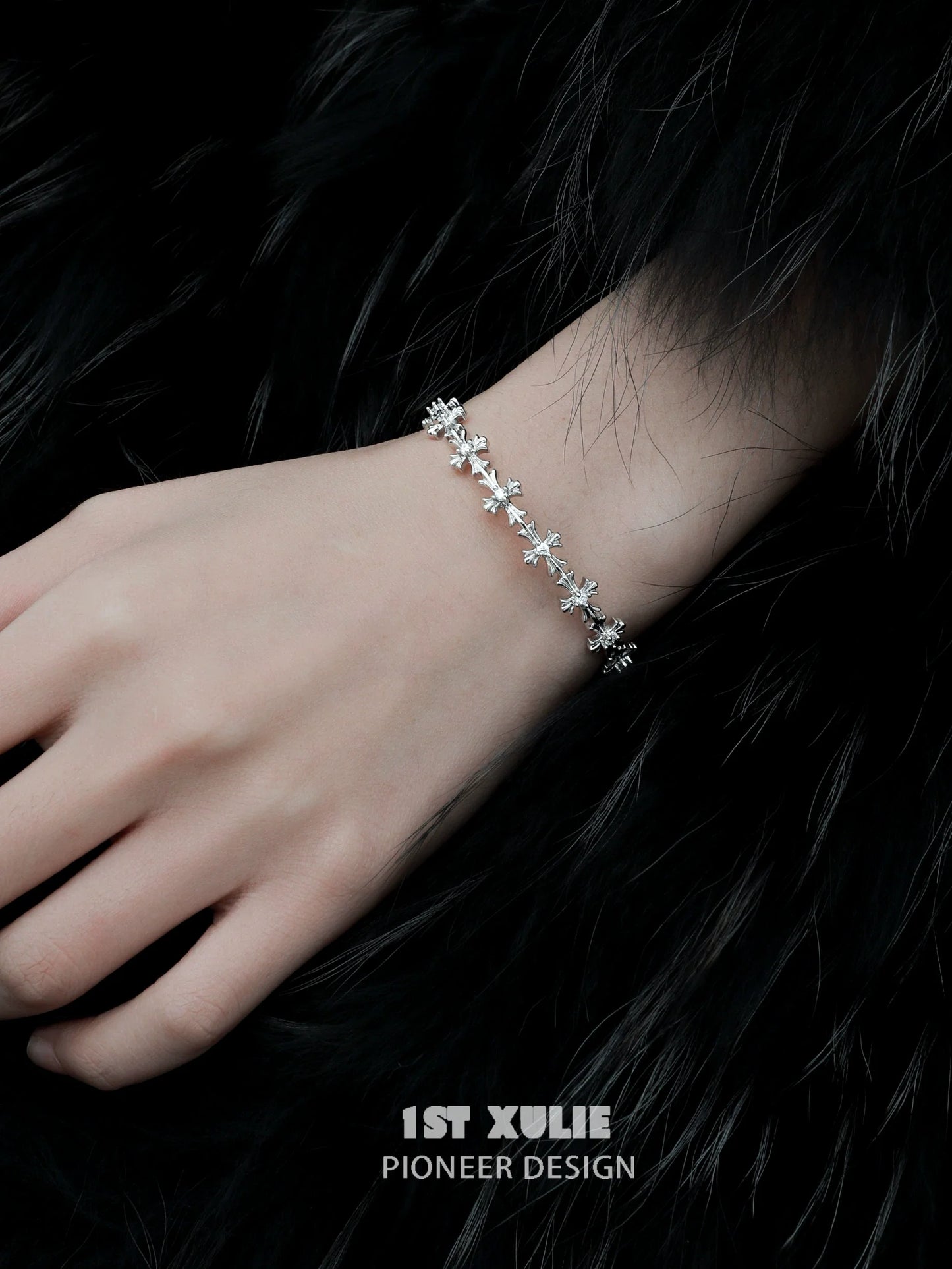 Elegant silver cross bracelet by 1ST XULIE with delicate cross designs and a shimmering finish