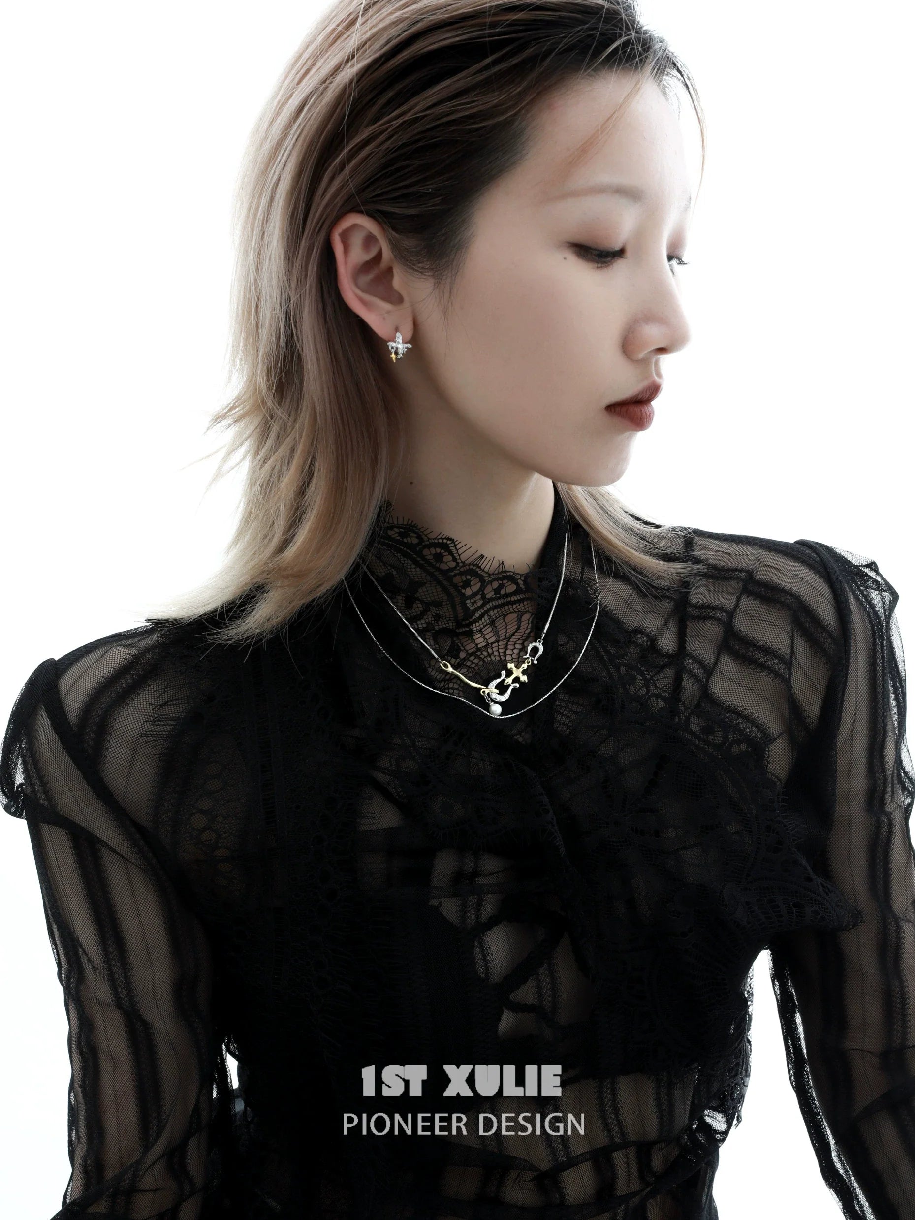 Model wearing elegant silver cross ear clips paired with a stylish black lace top