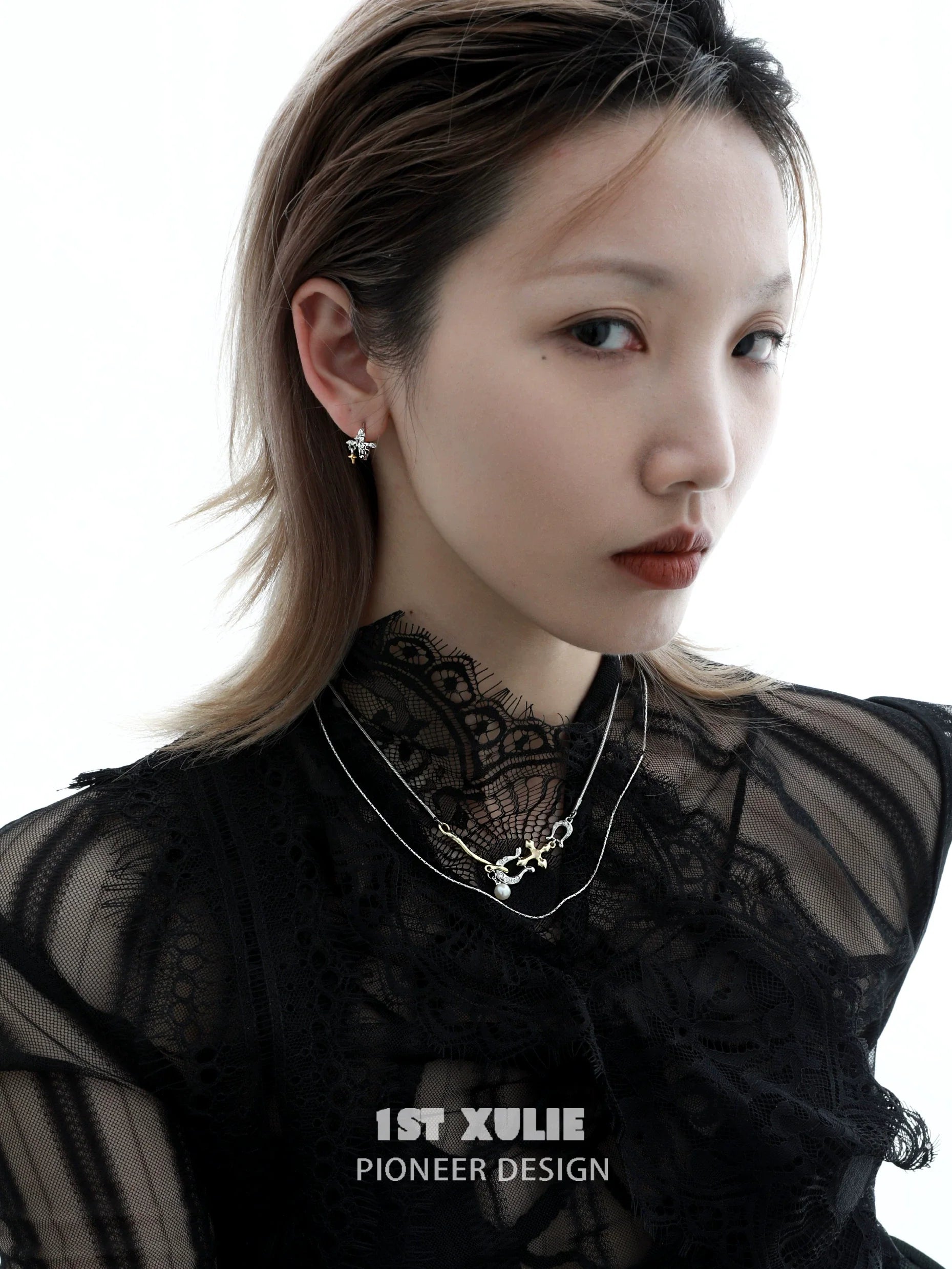 Stylish model wearing silver cross ear clips paired with layered necklaces for a chic look