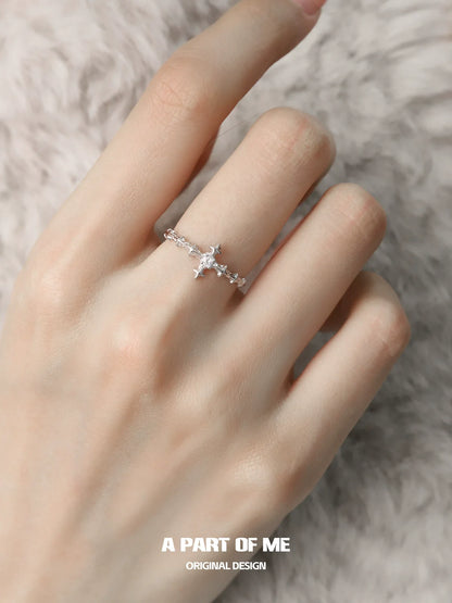 Delicate silver cross ring by A PART OF ME with intricate detailing on a model's hand