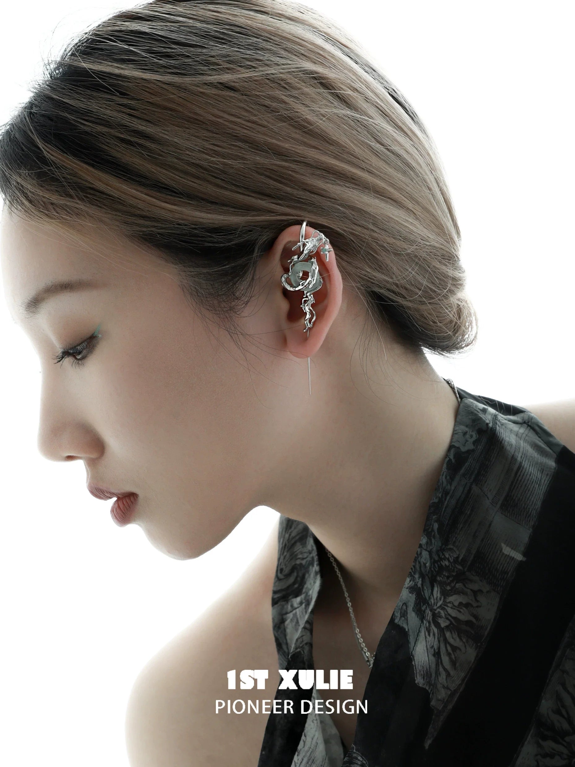 Model showcasing silver dragon ear piercing with unique design and sleek finish