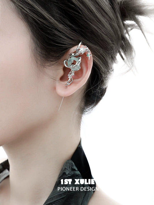 Elegant silver dragon ear piercing showcased on a model's ear with unique design details