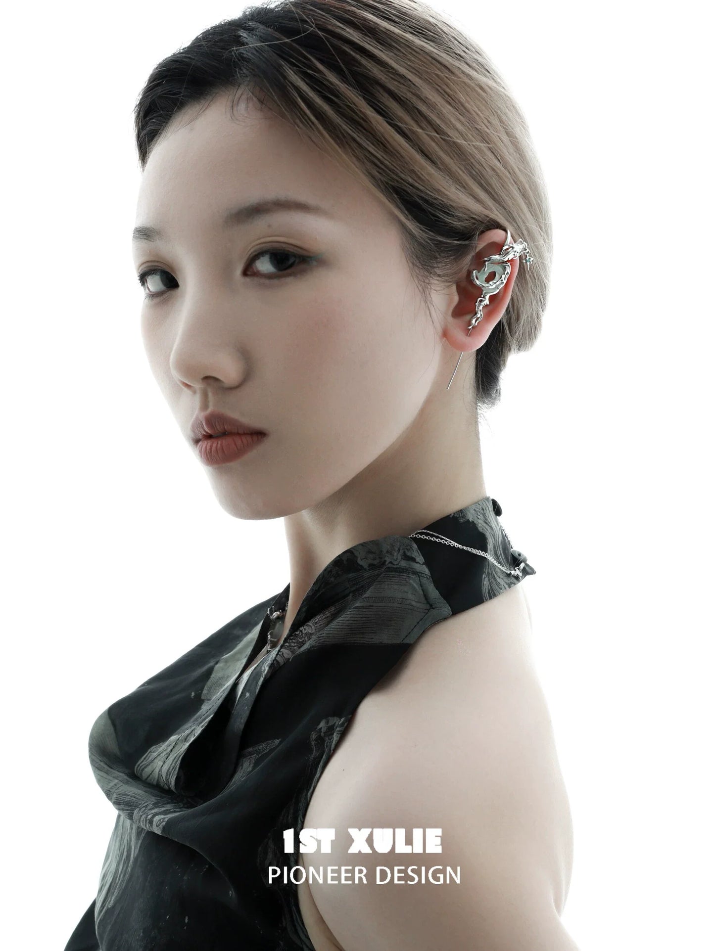 Elegant model showcasing silver dragon ear piercing, enhancing modern jewelry style