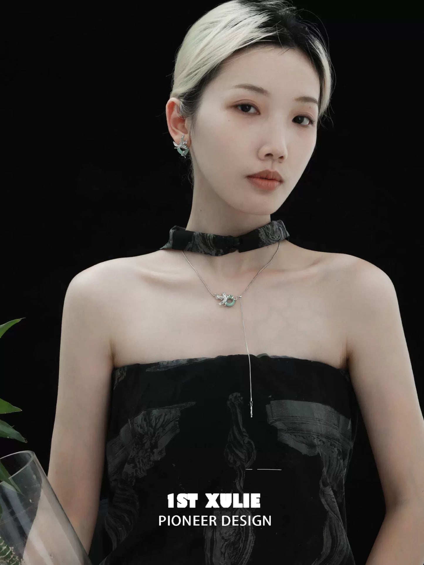 Elegant silver iris pull buckle necklace showcased on a model with a chic black outfit
