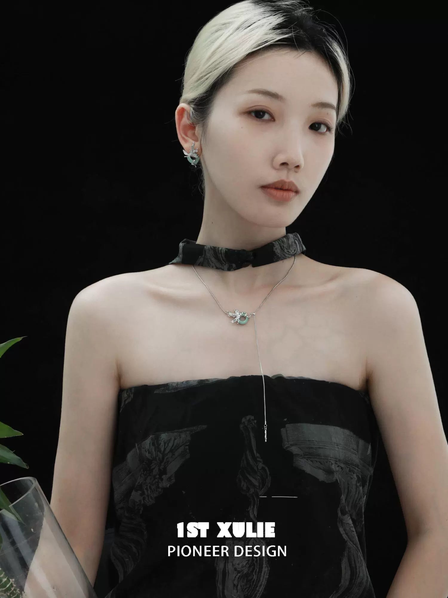 Elegant silver iris pull buckle necklace showcased on a model with a chic black outfit
