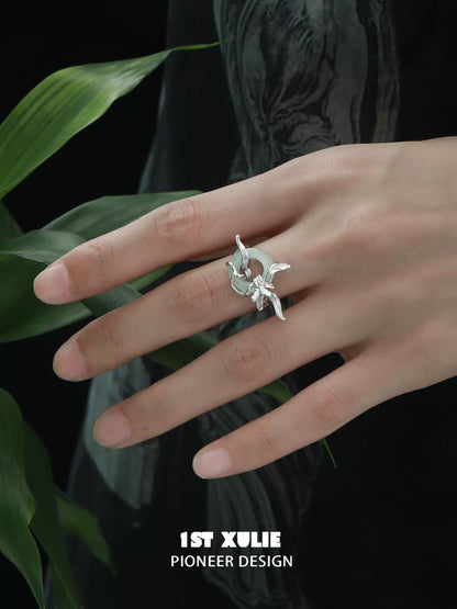 Silver Iris Safety Buckle Ring from 1ST XULIE with Unique Floral Design on Hand among Green Leaves