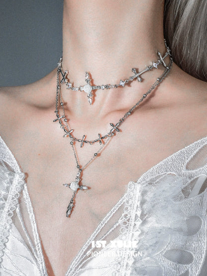 Elegant silver rose cross necklace layered with intricate cross designs and sparkling accents