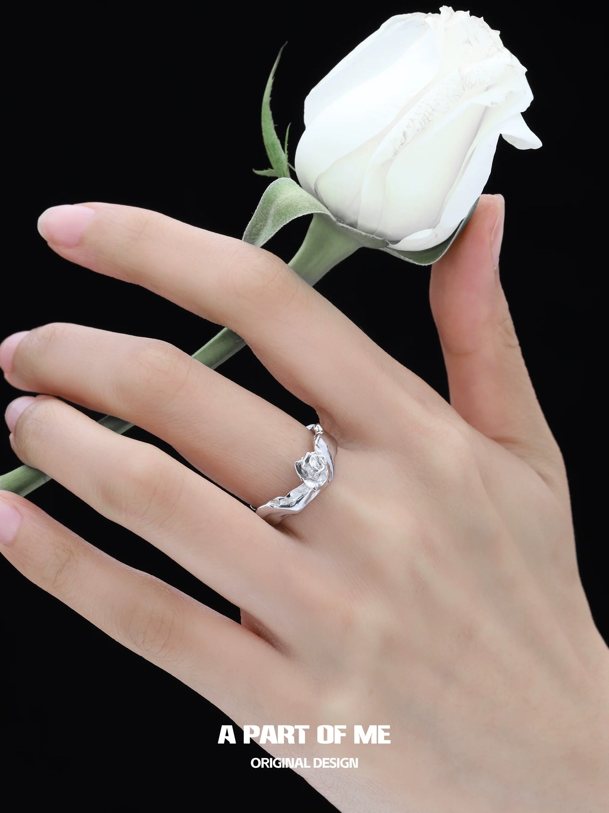 Silver rose ring from A PART OF ME elegantly worn on a hand holding a white rose