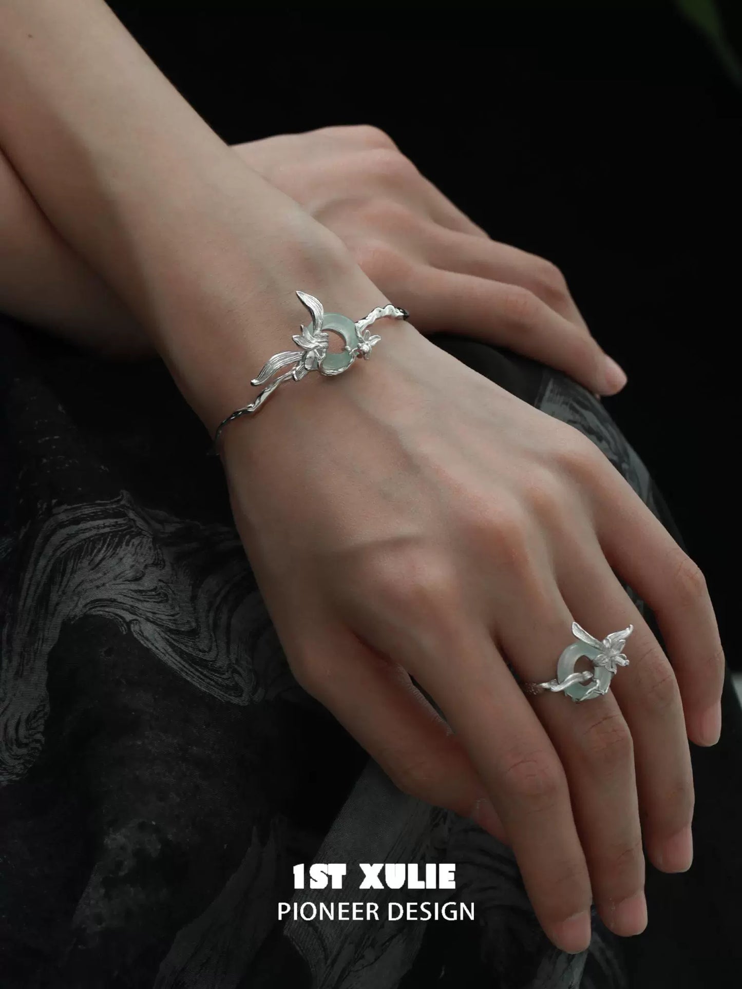 Elegant silver safety buckle bracelet on a hand, showcasing unique design and craftsmanship