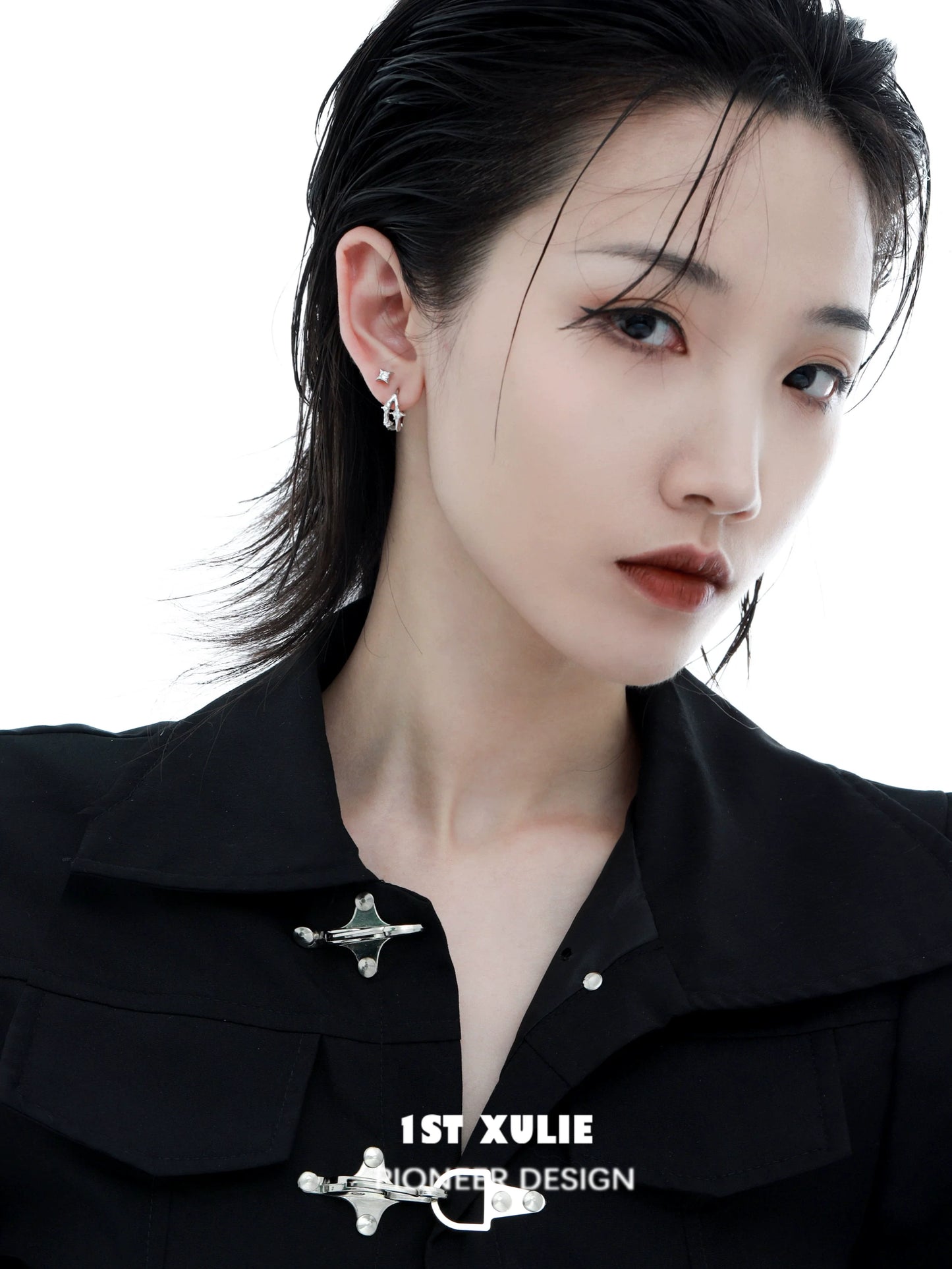Model wearing a silver star ear cuff from 1STXULIE, showcasing unique jewelry design and style.