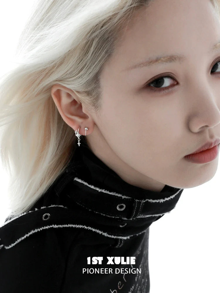 Stylish silver star earrings showcased on a model with a chic hairstyle