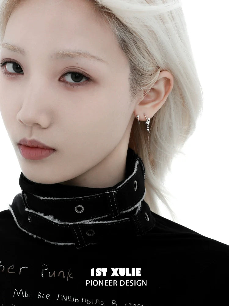 Model wearing 1STXULIE silver star earrings with a sleek black outfit and light blonde hair