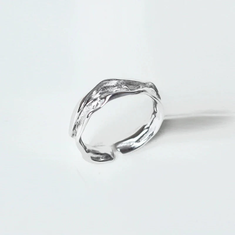 Artistic silver statement ring showcasing a unique textured design for bold fashion statements