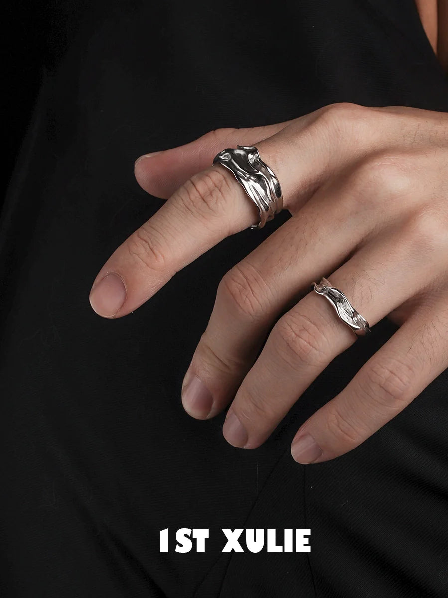 Elegant silver statement ring displayed on fingers, showcasing a unique wave design for stylish accessorizing