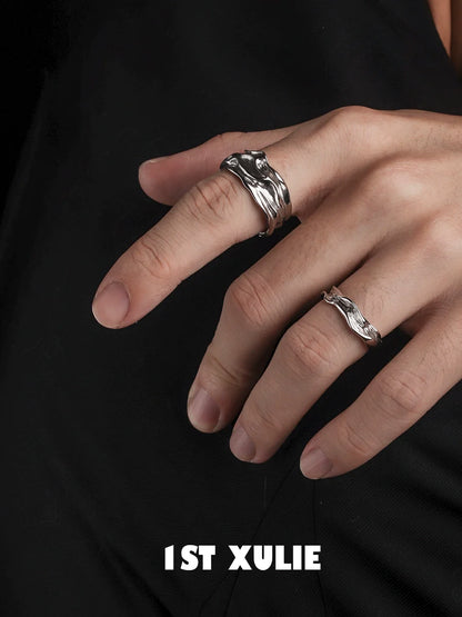 Elegant silver statement ring displayed on fingers, showcasing a unique wave design for stylish accessorizing