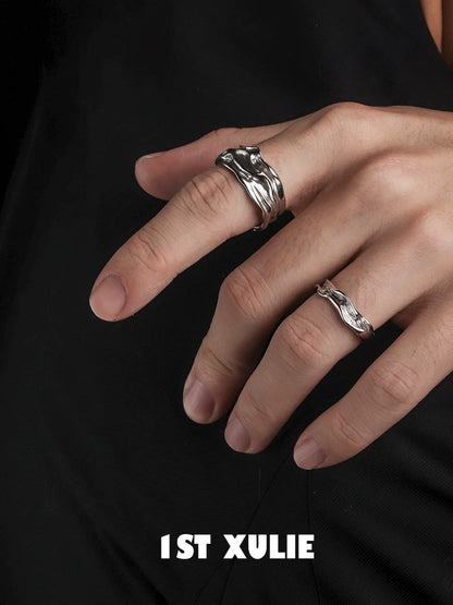 Two stylish silver statement rings on fingers showcasing unique wavy design for modern jewelry lovers