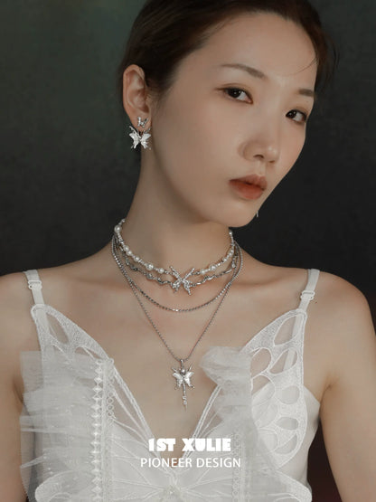 Layered skeleton butterfly pearl necklace with silver accents showcased on a model's neck